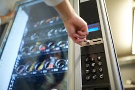 Customer using a vending machine with snacks inside